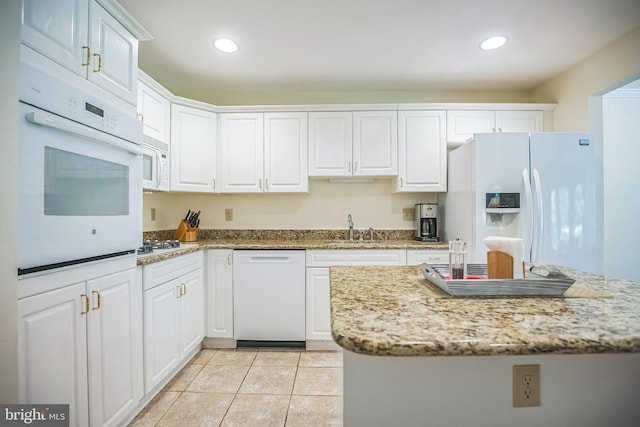 11 Birchwood Ct, Princeton, NJ 08540 - kitchen featuring white appliances, white cabinets, light tile patterned floors, recessed lighting, and light stone counters