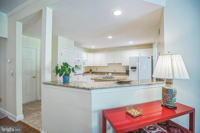 11 Birchwood Ct, Princeton, NJ 08540 - kitchen featuring white appliances, light stone counters, white cabinetry, a peninsula, and recessed lighting