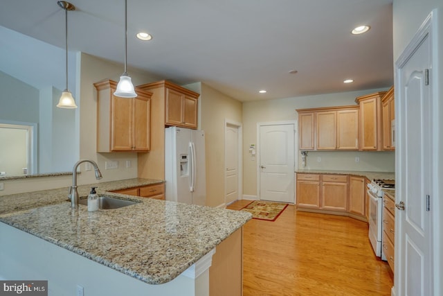 18208 Emerson Way, Georgetown, DE 19947 - kitchen featuring white appliances, a peninsula, light stone countertops, pendant lighting, and light wood-style flooring