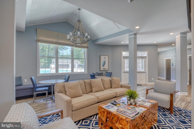 18208 Emerson Way, Georgetown, DE 19947 - living area with ornate columns, a chandelier, healthy amount of natural light, wood finished floors, and vaulted ceiling