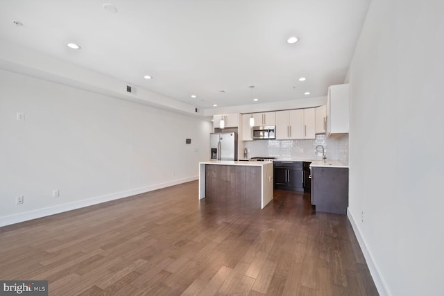 525 Kennedy St NW Unit 4, Washington, DC 20011 - kitchen featuring stainless steel appliances, a kitchen island, a sink, light countertops, and decorative backsplash