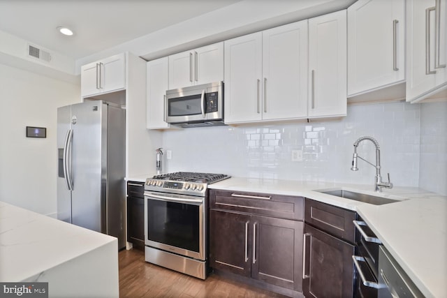 525 Kennedy St NW Unit 4, Washington, DC 20011 - kitchen with appliances with stainless steel finishes, a sink, white cabinetry, dark wood-style floors, and dark brown cabinets