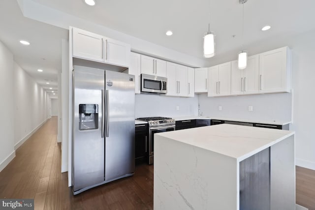 525 Kennedy St NW Unit 4, Washington, DC 20011 - kitchen with stainless steel appliances, dark wood-type flooring, recessed lighting, a kitchen island, and white cabinetry