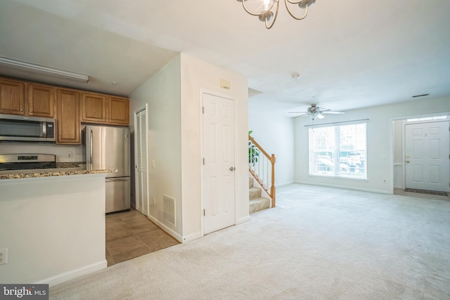 5932 Kimberly Anne Way, Alexandria, VA 22310 - kitchen featuring appliances with stainless steel finishes, light carpet, brown cabinetry, and baseboards