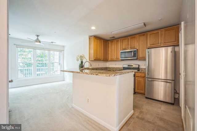 5932 Kimberly Anne Way, Alexandria, VA 22310 - kitchen featuring stainless steel appliances, recessed lighting, a peninsula, light stone counters, and ceiling fan