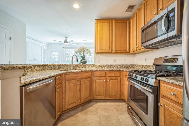 5932 Kimberly Anne Way, Alexandria, VA 22310 - kitchen featuring appliances with stainless steel finishes, a sink, ceiling fan, light stone countertops, and recessed lighting