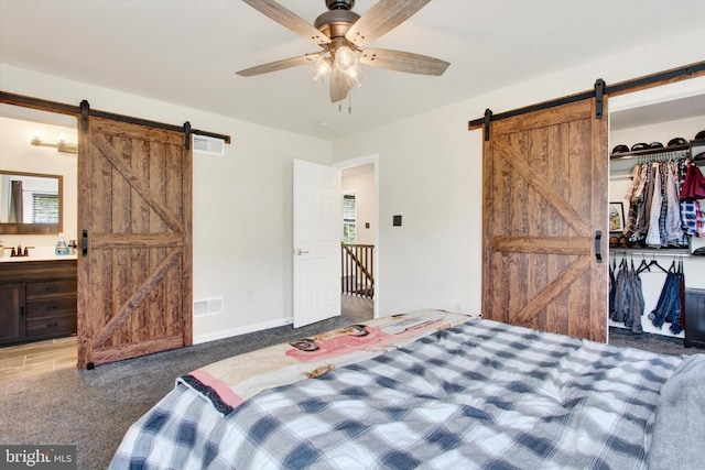 2536 Stoverstown Rd, Spring Grove, PA 17362 - carpeted bedroom featuring a barn door, a sink, ensuite bath, and a ceiling fan