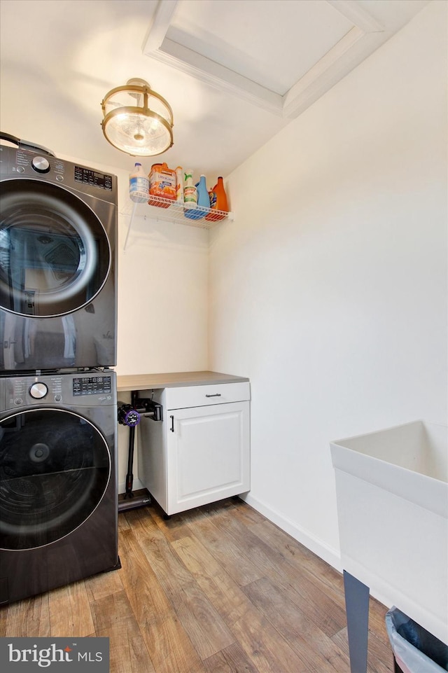 2536 Stoverstown Rd, Spring Grove, PA 17362 - laundry room featuring stacked washer / drying machine, cabinet space, and light wood finished floors