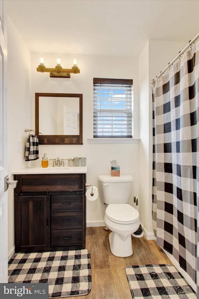 2536 Stoverstown Rd, Spring Grove, PA 17362 - full bathroom featuring wood finished floors, toilet, vanity, baseboards, and a shower with curtain
