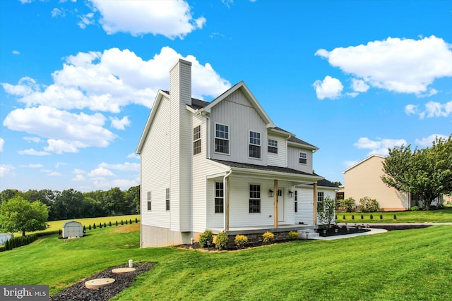 2536 Stoverstown Rd, Spring Grove, PA 17362 - view of front facade featuring a porch, a front yard, a chimney, and board and batten siding