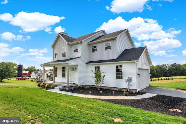 2536 Stoverstown Rd, Spring Grove, PA 17362 - view of front of house featuring covered porch, a garage, a front yard, driveway, and a shingled roof