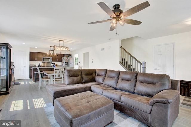 2536 Stoverstown Rd, Spring Grove, PA 17362 - living room featuring light wood finished floors, a ceiling fan, recessed lighting, stairs, and a chandelier