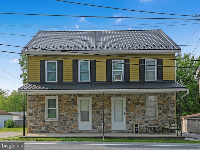 41 W George St, York, PA 17408 - view of front facade with stone siding, a porch, and metal roof