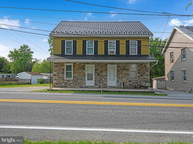 41 W George St, York, PA 17408 - view of front of home featuring stone siding, metal roof, and covered porch