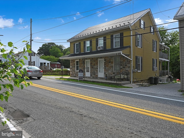 41 W George St, York, PA 17408 - view of front of house featuring stone siding, a porch, and metal roof