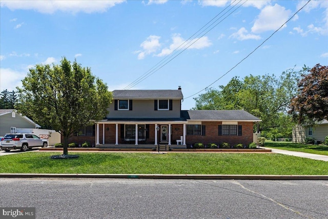 1609 Wills Pl, Vineland, NJ 08361 - traditional-style home with brick siding, a front yard, and covered porch