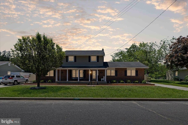 1609 Wills Pl, Vineland, NJ 08361 - traditional home with covered porch, a front lawn, brick siding, and concrete driveway