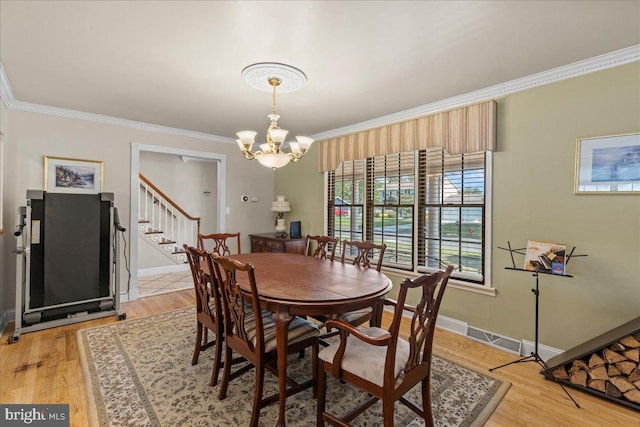 1609 Wills Pl, Vineland, NJ 08361 - dining area featuring ornamental molding, a chandelier, stairway, light wood-style floors, and baseboards