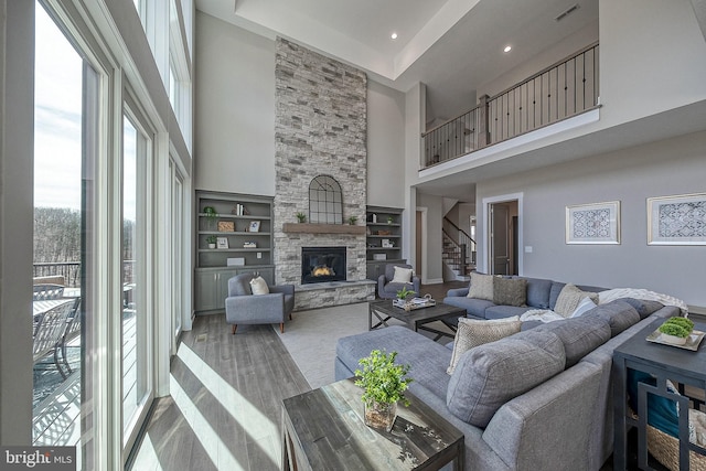547 Webb Rd # Ad, Chadds Ford, PA 19317 - living area featuring a high ceiling, stairs, a fireplace, built in shelves, and wood finished floors
