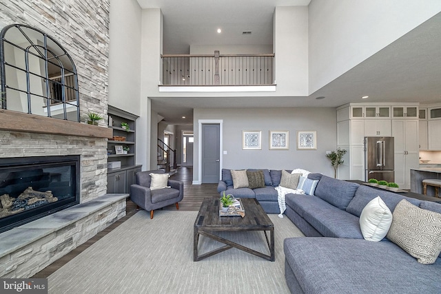 547 Webb Rd # Ad, Chadds Ford, PA 19317 - living area featuring a towering ceiling, a stone fireplace, stairway, recessed lighting, and built in features
