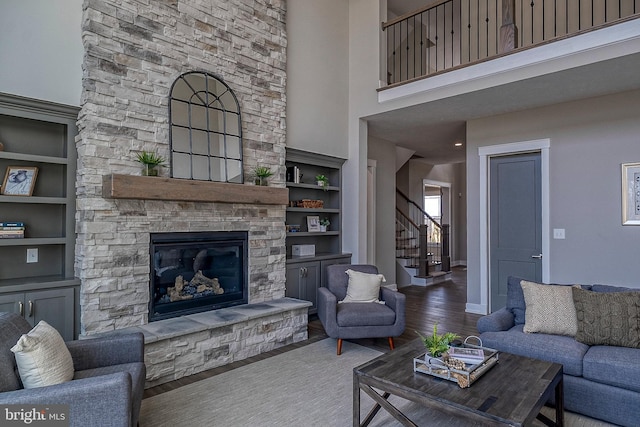 547 Webb Rd # Ad, Chadds Ford, PA 19317 - living area with stairway, wood finished floors, built in shelves, a stone fireplace, and a towering ceiling