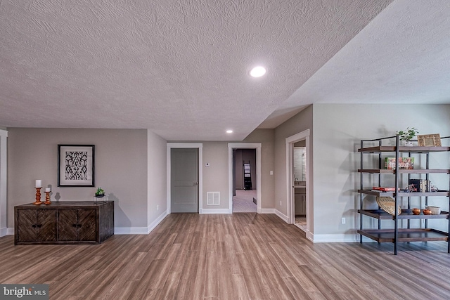 547 Webb Rd # Ad, Chadds Ford, PA 19317 - unfurnished living room with wood finished floors, a textured ceiling, baseboards, and recessed lighting