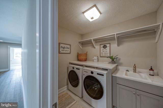 547 Webb Rd # Ad, Chadds Ford, PA 19317 - laundry room with washer and clothes dryer, a textured ceiling, cabinet space, light wood finished floors, and baseboards
