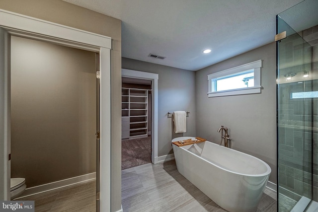 547 Webb Rd # Ad, Chadds Ford, PA 19317 - bathroom featuring a spacious closet, a freestanding tub, a stall shower, toilet, and baseboards