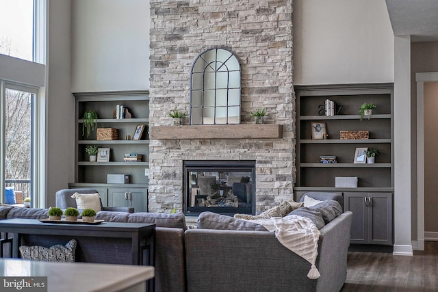 547 Webb Rd # Ad, Chadds Ford, PA 19317 - living area with a stone fireplace, dark wood finished floors, built in features, baseboards, and a high ceiling