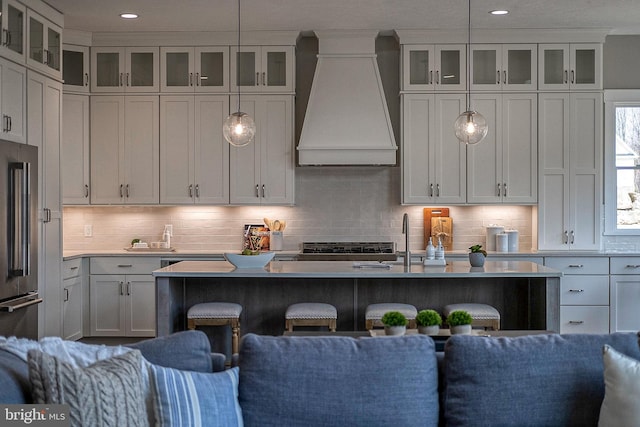 547 Webb Rd # Ad, Chadds Ford, PA 19317 - kitchen with wall chimney range hood, high quality fridge, a breakfast bar area, light countertops, and backsplash