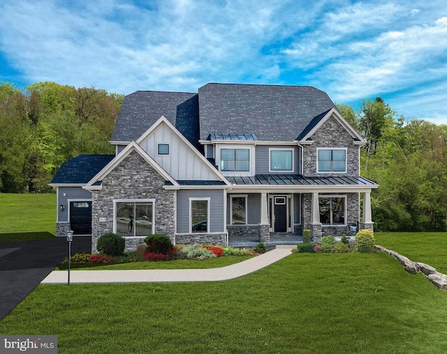 547 Webb Rd # Ad, Chadds Ford, PA 19317 - craftsman-style house with stone siding, covered porch, a front yard, and board and batten siding