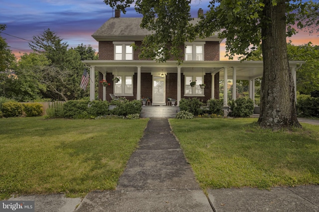 1749 Carrolls Tract Rd, Orrtanna, PA 17353 - view of front of house with brick siding, a front lawn, and covered porch