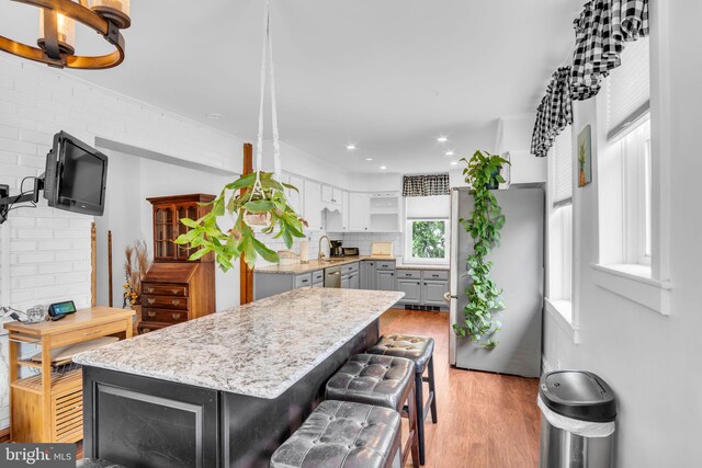 1749 Carrolls Tract Rd, Orrtanna, PA 17353 - kitchen featuring freestanding refrigerator, gray cabinetry, tasteful backsplash, light wood-style flooring, and open shelves