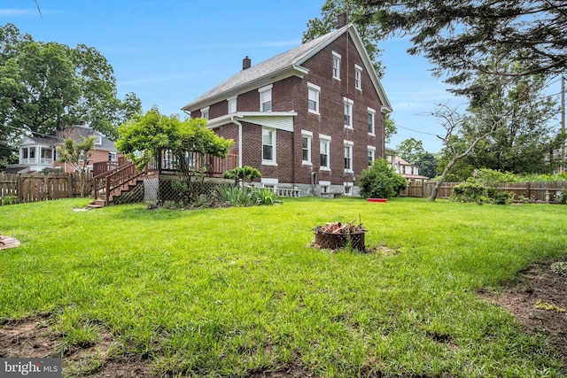 1749 Carrolls Tract Rd, Orrtanna, PA 17353 - view of home's exterior featuring brick siding, a wooden deck, a fire pit, a chimney, and stairs