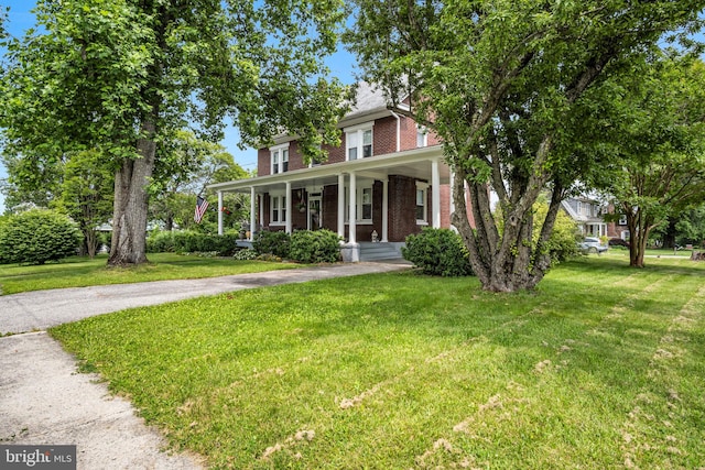 1749 Carrolls Tract Rd, Orrtanna, PA 17353 - view of front of home featuring brick siding, a front lawn, and covered porch