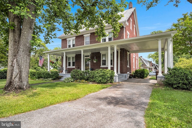 1749 Carrolls Tract Rd, Orrtanna, PA 17353 - view of front facade featuring brick siding, covered porch, driveway, a front lawn, and a chimney