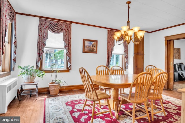 1749 Carrolls Tract Rd, Orrtanna, PA 17353 - dining area with radiator, ornamental molding, light wood-style flooring, a chandelier, and baseboards