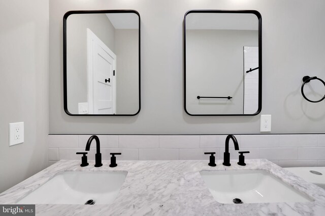 4019 9th St NE Unit 3, Washington, DC 20017 - bathroom featuring double vanity and decorative backsplash
