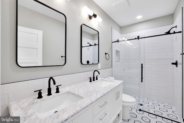 4019 9th St NE Unit 3, Washington, DC 20017 - full bath with tile walls, a stall shower, toilet, and double vanity