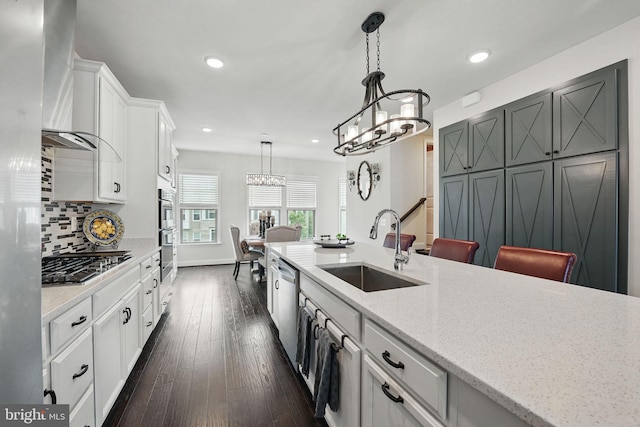 2069 Alder Ln, Dumfries, VA 22026 - kitchen with wall chimney exhaust hood, a sink, stainless steel appliances, a chandelier, and recessed lighting