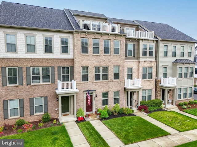 2069 Alder Ln, Dumfries, VA 22026 - view of property with a front yard, brick siding, and a residential view
