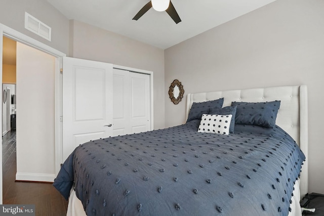 2069 Alder Ln, Dumfries, VA 22026 - bedroom with dark wood-style floors, a closet, ceiling fan, and baseboards