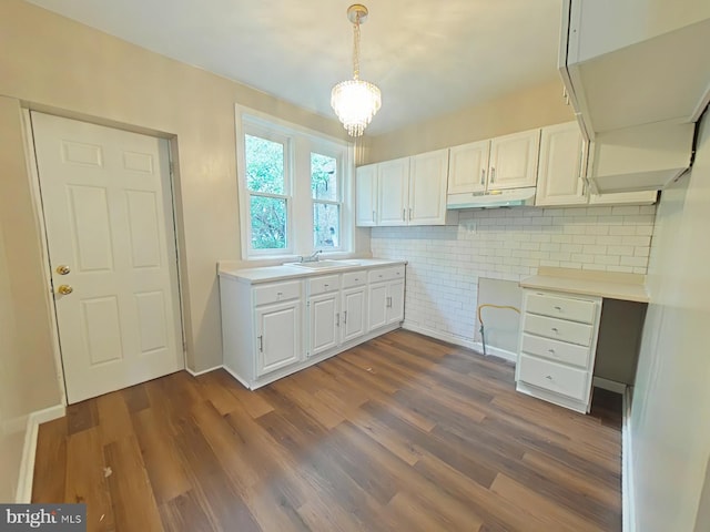 4019 N Marshall St, Philadelphia, PA 19140 - kitchen with under cabinet range hood, dark wood-style floors, tasteful backsplash, and white cabinets