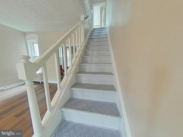 4019 N Marshall St, Philadelphia, PA 19140 - stairway featuring wood finished floors and radiator