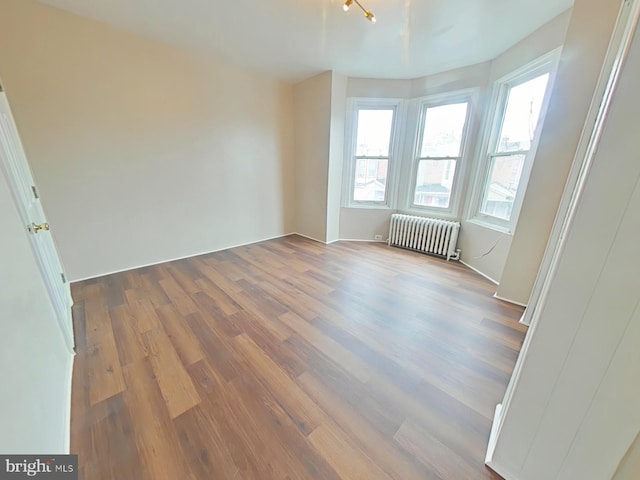 4019 N Marshall St, Philadelphia, PA 19140 - empty room with radiator heating unit, wood finished floors, and healthy amount of natural light