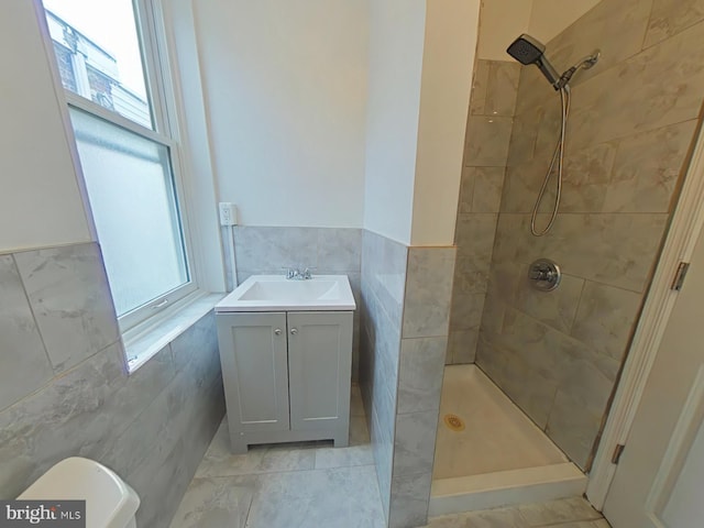 4019 N Marshall St, Philadelphia, PA 19140 - full bathroom featuring tile walls, tiled shower, wainscoting, and vanity