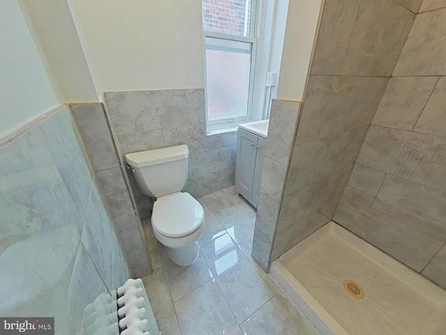 4019 N Marshall St, Philadelphia, PA 19140 - bathroom with tile walls, vanity, wainscoting, radiator heating unit, and a tile shower