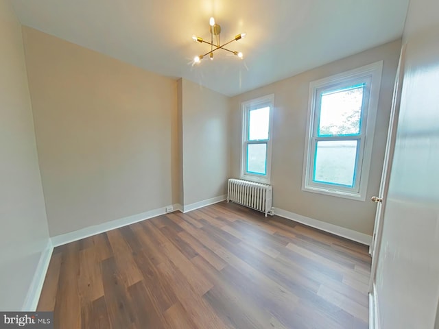4019 N Marshall St, Philadelphia, PA 19140 - unfurnished room with radiator, a chandelier, and wood finished floors