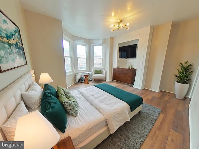 4019 N Marshall St, Philadelphia, PA 19140 - bedroom with a chandelier, wood finished floors, and radiator heating unit