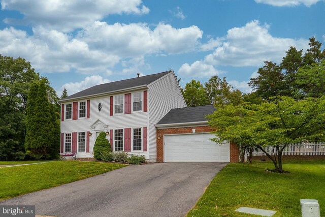 6814 Springshire Way, Greenbelt, MD 20770 - colonial home featuring asphalt driveway, an attached garage, brick siding, and a shingled roof
